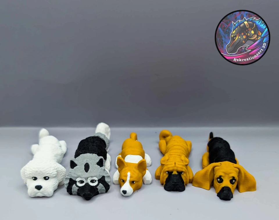 Five 3D-printed dog figurines lined up in a row.