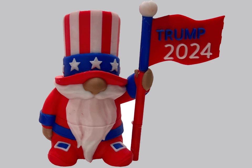 3D-printed gnome holding a "Trump 2024" flag.