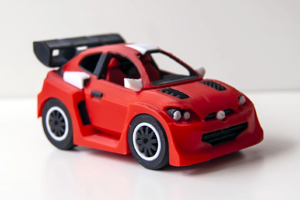 Red 3D-printed race car model with detailed design.